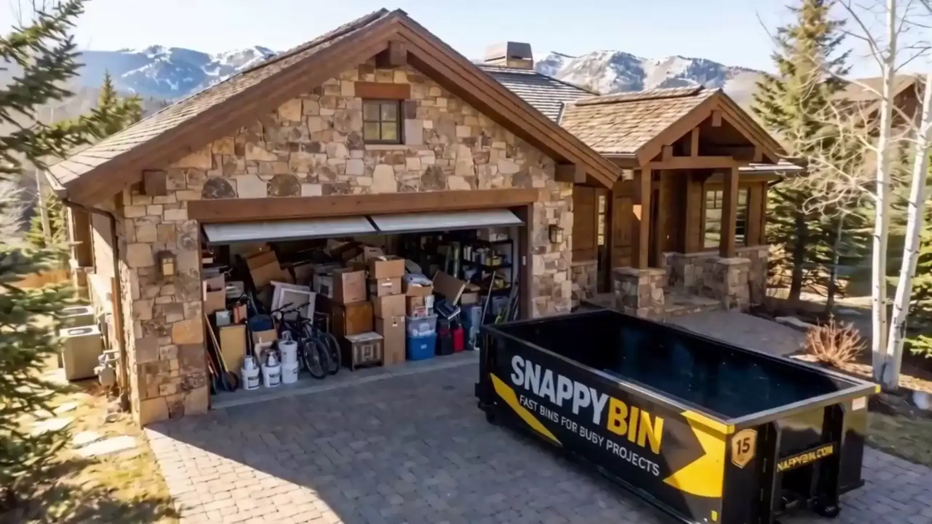SnappyBin dumpster truck delivering a bin in a Park City driveway