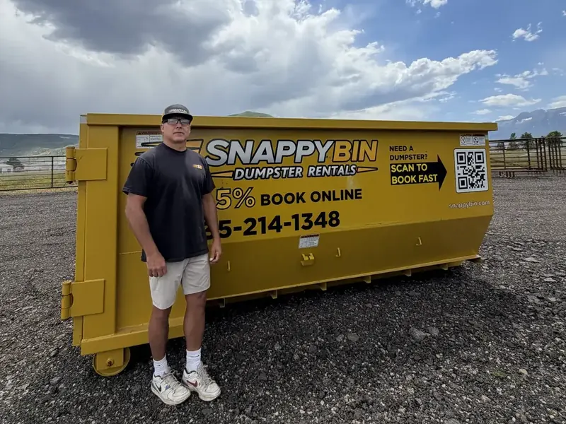 Snappy Bin owner Mike Vleck beside a yellow dumpster