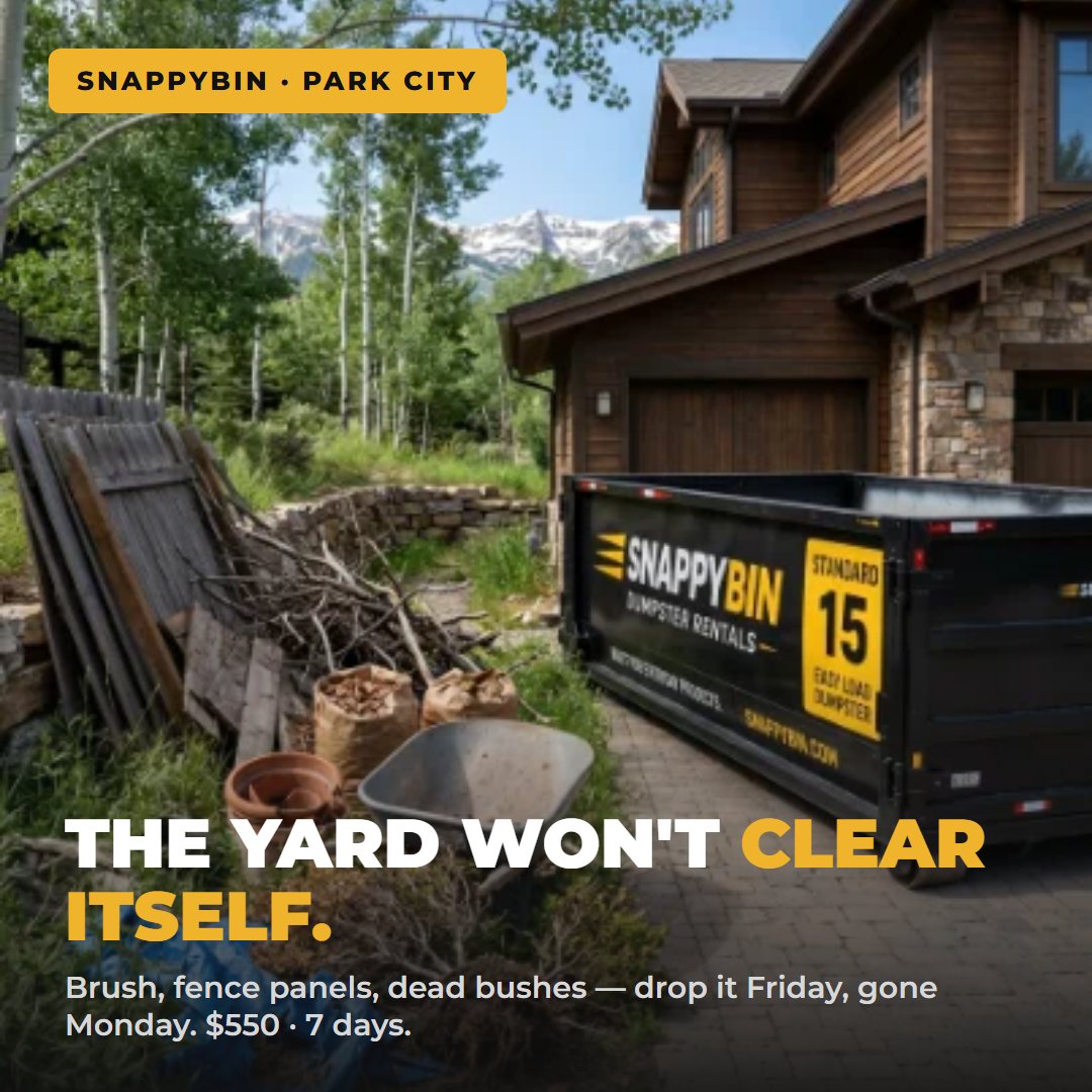 Yard debris and brush pile next to a SnappyBin Standard 15 dumpster rental at a Park City mountain home
